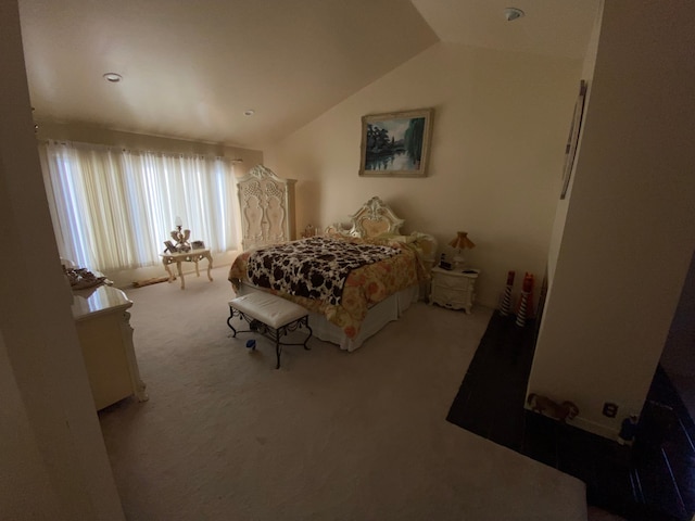 carpeted bedroom featuring lofted ceiling