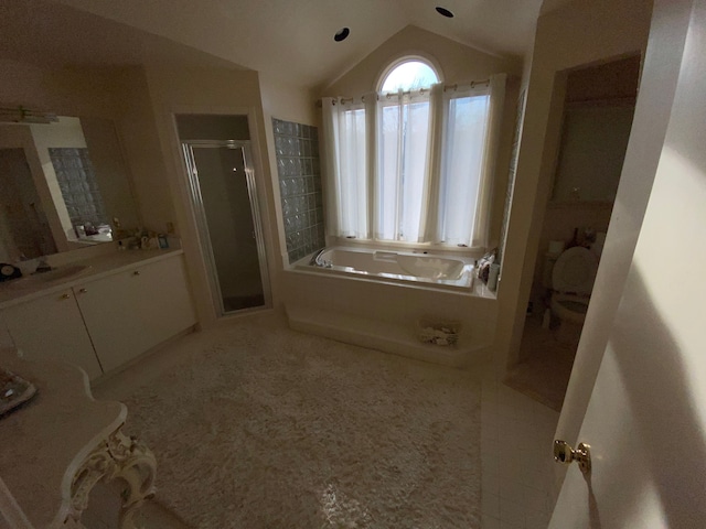 full bath with a stall shower, tile patterned flooring, a bath, vanity, and vaulted ceiling