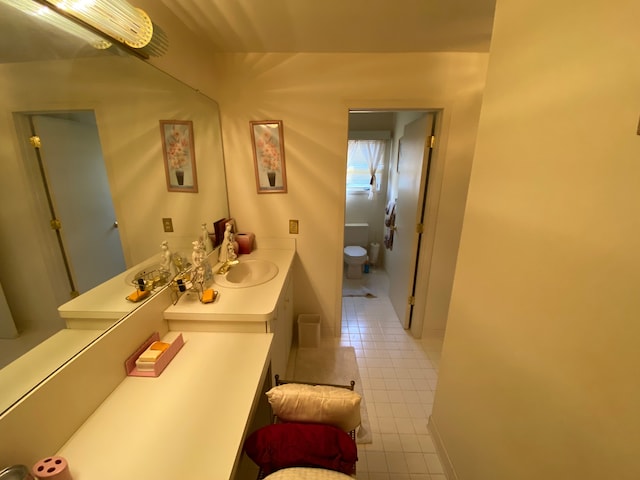 bathroom featuring tile patterned flooring, toilet, and vanity