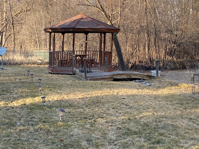 view of yard with a deck, a gazebo, and fence