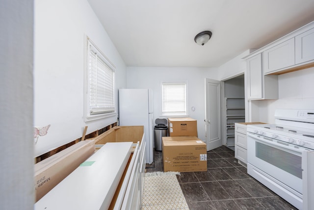 kitchen featuring white appliances, white cabinets, and light countertops