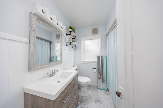 full bathroom featuring visible vents, a wainscoted wall, toilet, marble finish floor, and vanity