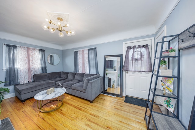 living area with a chandelier and light wood-style flooring