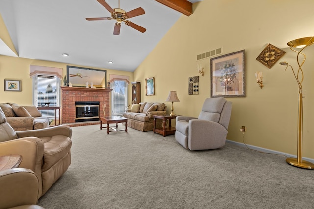 carpeted living area with beamed ceiling, visible vents, ceiling fan, and a fireplace