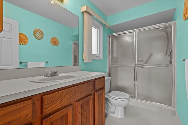 full bath with toilet, a stall shower, tile patterned floors, and vanity