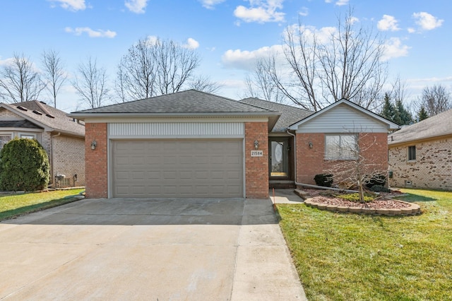 ranch-style house with a garage, brick siding, driveway, and a front yard