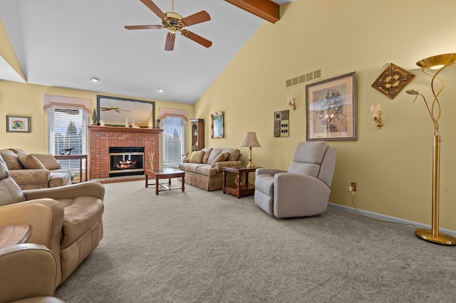 carpeted living room with beamed ceiling, a brick fireplace, visible vents, a ceiling fan, and high vaulted ceiling
