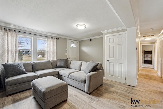 living room with crown molding, light wood-style flooring, and a textured ceiling