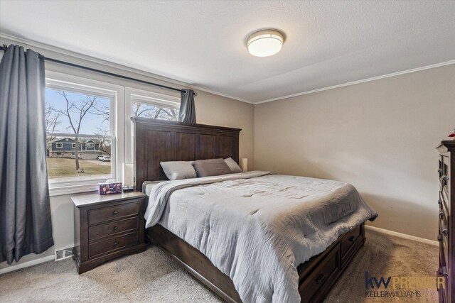 bedroom featuring crown molding, light colored carpet, visible vents, and baseboards