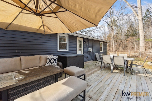 wooden deck with an outdoor living space, outdoor dining area, and fence