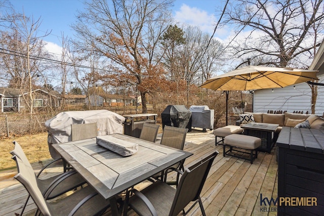 wooden terrace with an outdoor living space, area for grilling, outdoor dining space, and fence