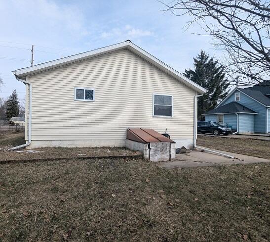 view of home's exterior with a yard