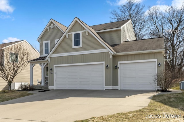 view of front of house featuring a garage, driveway, and a shingled roof