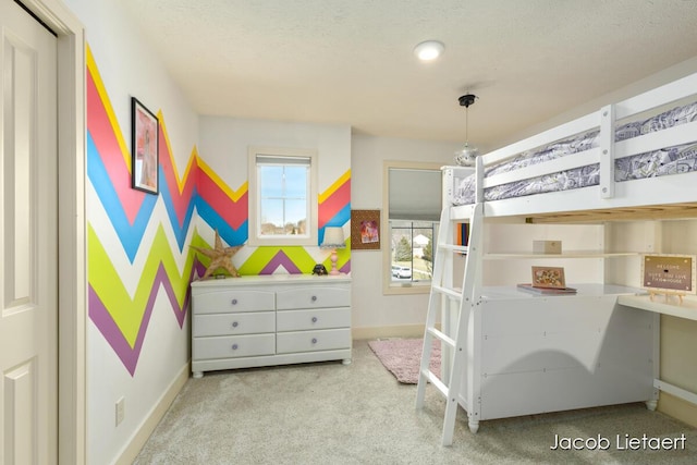 carpeted bedroom featuring baseboards