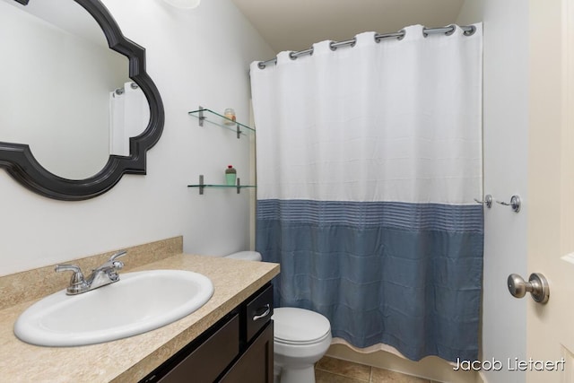 bathroom with tile patterned flooring, curtained shower, toilet, and vanity