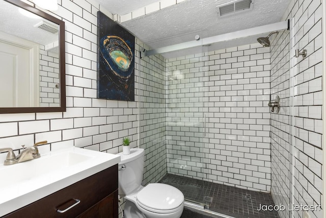 full bath with visible vents, toilet, a textured ceiling, and a shower stall