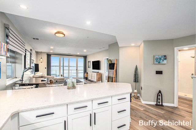 2964 Lakeshore Dr Unit E 304, Muskegon, MI 49441 - kitchen featuring visible vents, open floor plan, white cabinetry, recessed lighting, and light wood-style floors