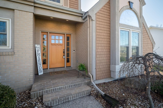 entrance to property featuring brick siding