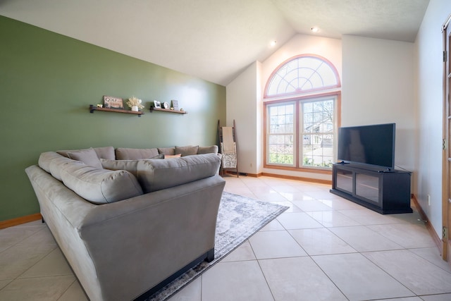 living room with baseboards, high vaulted ceiling, and light tile patterned flooring