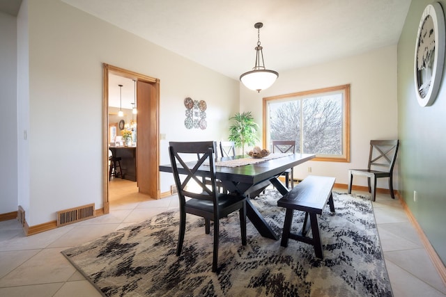 dining area featuring visible vents, baseboards, and light tile patterned flooring