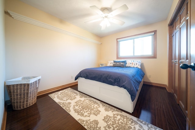 bedroom featuring a closet, a ceiling fan, baseboards, and wood finished floors