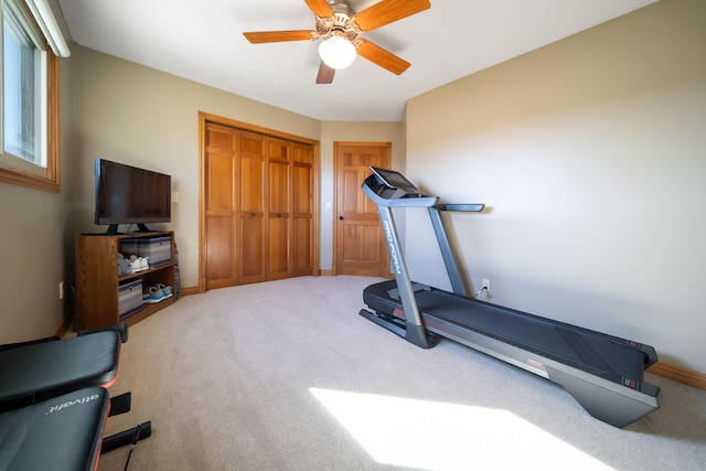 exercise area with a ceiling fan, carpet, and baseboards