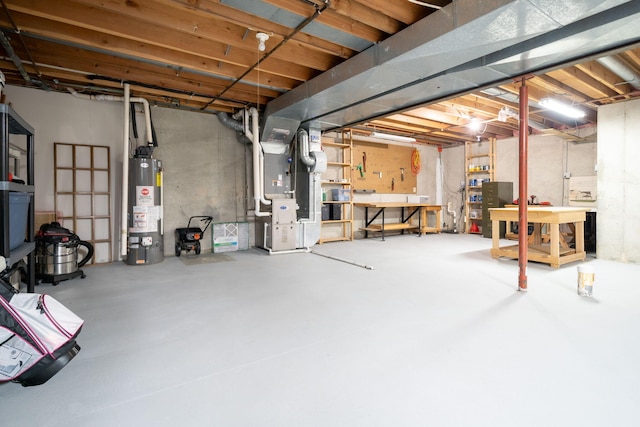 unfinished basement featuring water heater, heating unit, and a workshop area