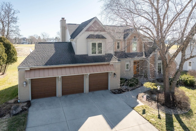 view of front of home featuring a shingled roof, concrete driveway, brick siding, and a chimney