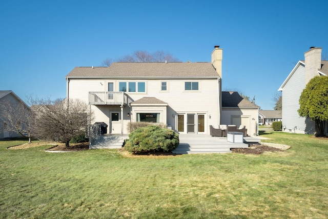 rear view of property featuring a yard, a balcony, and a chimney