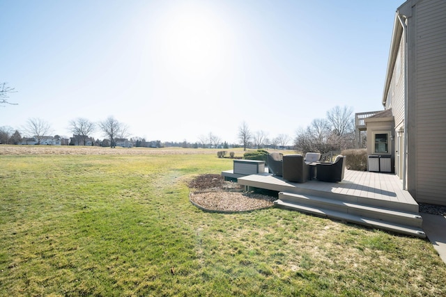 view of yard with a deck and a rural view