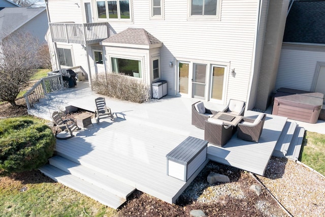 wooden deck featuring a hot tub