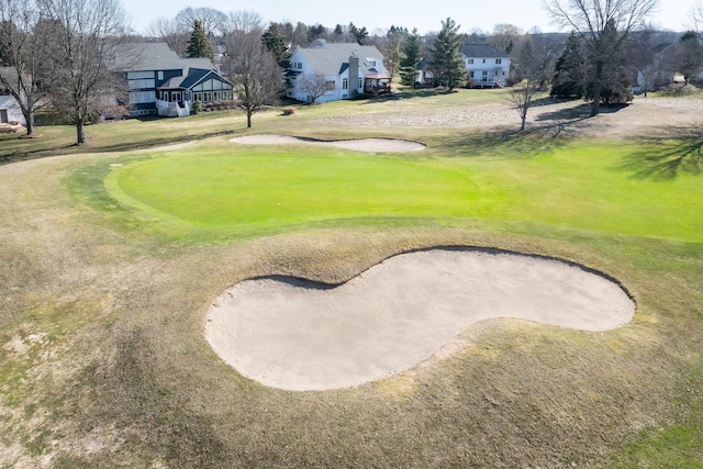 view of home's community featuring a yard and view of golf course