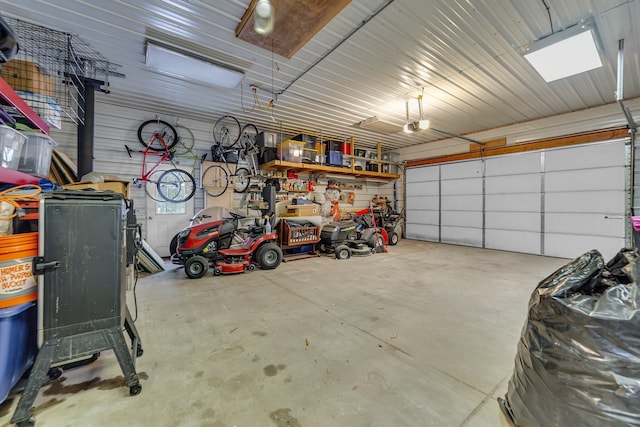 garage featuring metal wall and a garage door opener