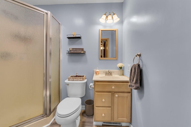 bathroom with vanity, toilet, visible vents, and a stall shower