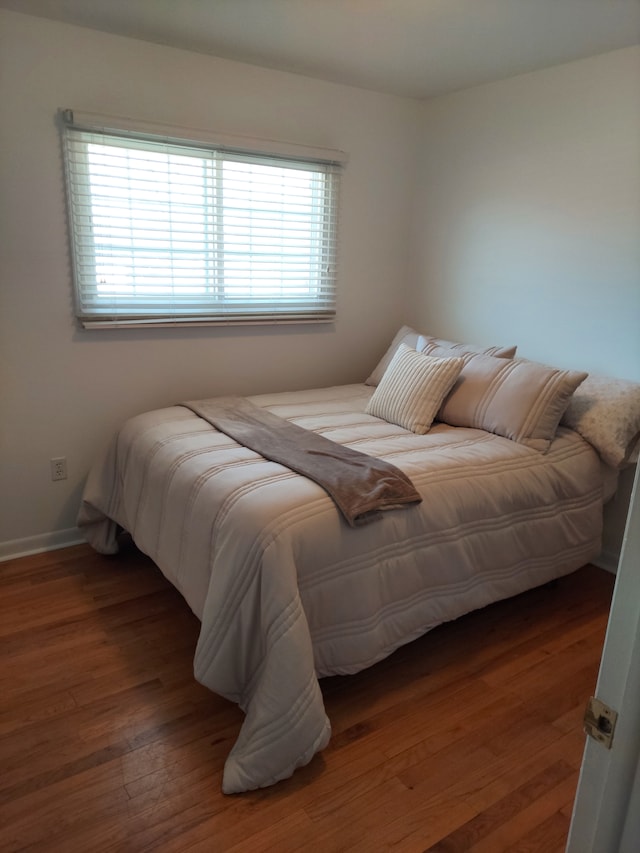 bedroom featuring wood finished floors