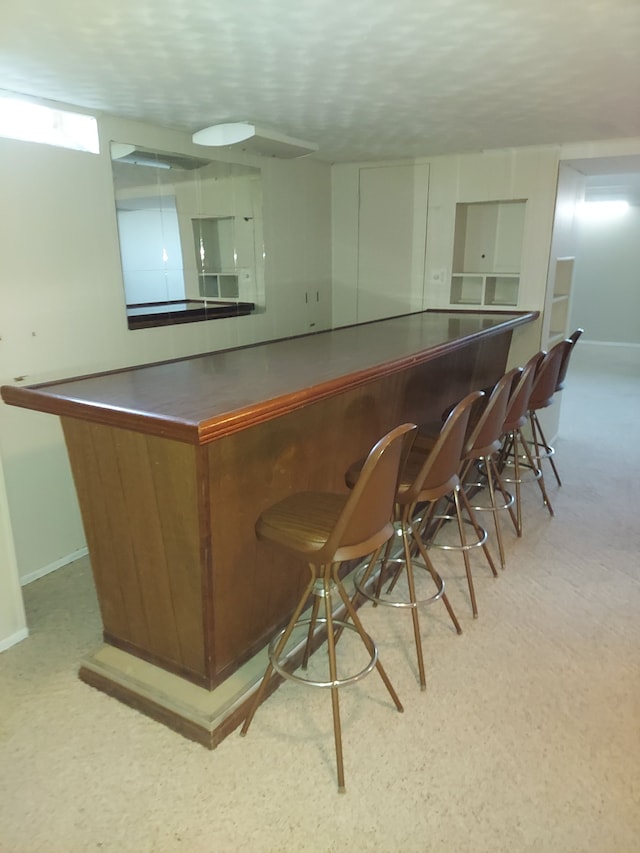 bar with baseboards and a bar