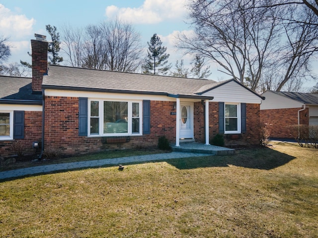 single story home with brick siding, a chimney, a front lawn, and a shingled roof