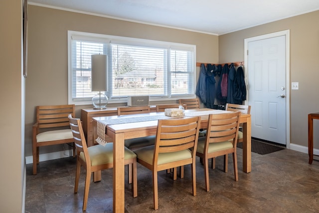 dining room featuring baseboards and ornamental molding