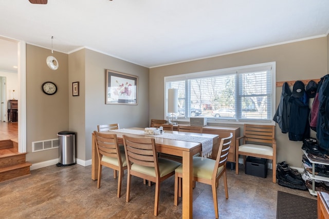 dining space with baseboards, visible vents, and ornamental molding