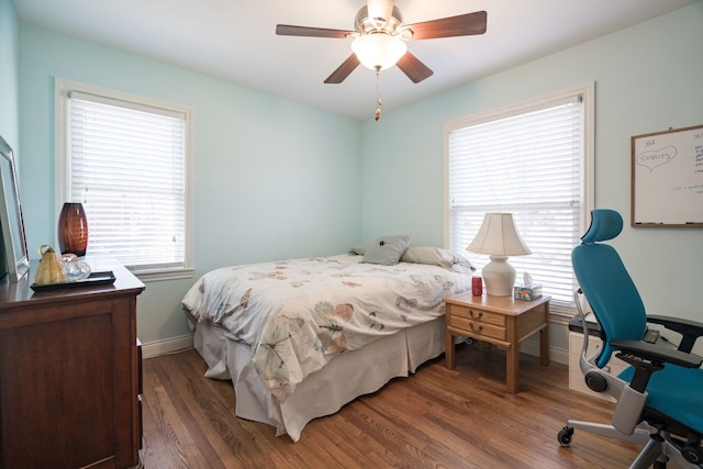 bedroom featuring ceiling fan, baseboards, and wood finished floors