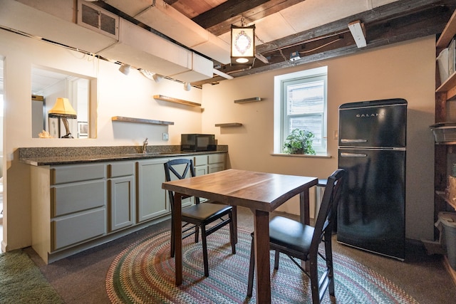 dining space featuring beamed ceiling and visible vents