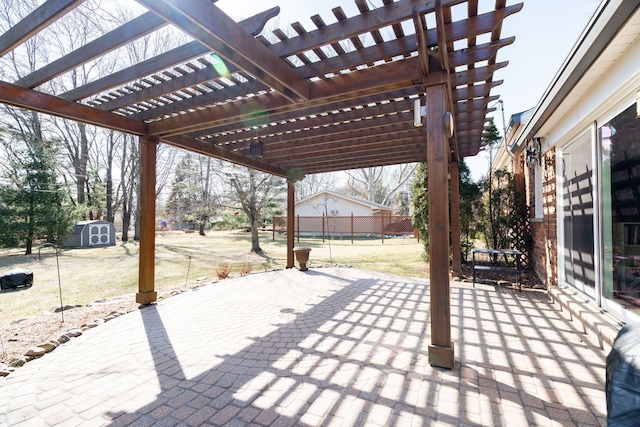 view of patio featuring an outbuilding, a storage unit, and a pergola