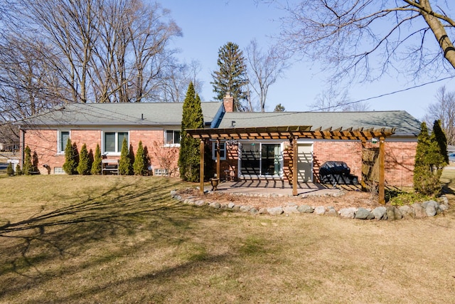 back of house featuring a patio, a yard, a pergola, a chimney, and brick siding