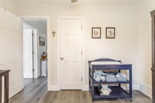 interior space featuring visible vents, baseboards, and wood finished floors