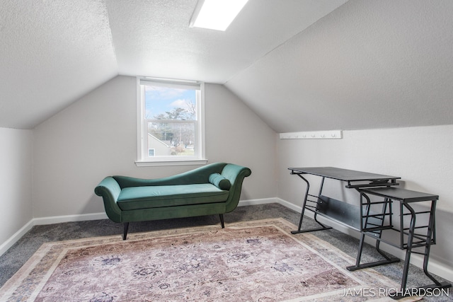 sitting room with carpet floors, a textured ceiling, baseboards, and vaulted ceiling