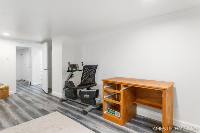 exercise area with crown molding, wood finished floors, and baseboards