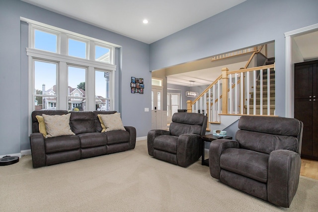 carpeted living area with stairway, recessed lighting, and baseboards