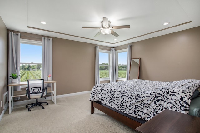 bedroom featuring light carpet, recessed lighting, multiple windows, and baseboards