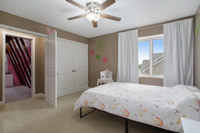 bedroom with light colored carpet, a closet, and ceiling fan