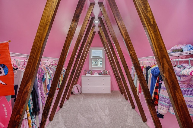 unfurnished bedroom featuring lofted ceiling and carpet